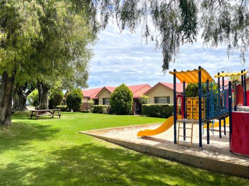 a playground with a slide in a park at Busselton Villas and Glamping Village in Busselton