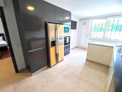 a kitchen with a stainless steel refrigerator at Lisbon Airport GuestHouse GAL Olivais Conforto, Terraço e Localização Premium nos Olivais in Lisbon