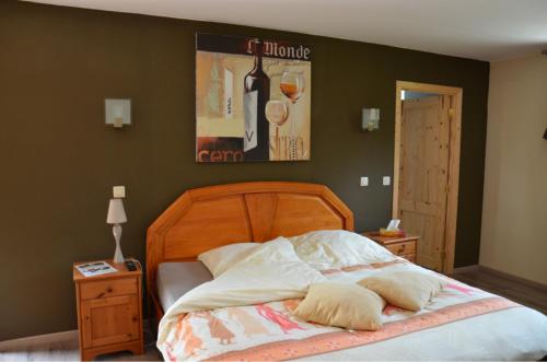 a bed with two pillows on it in a bedroom at Forges de Pernelle in Couvin