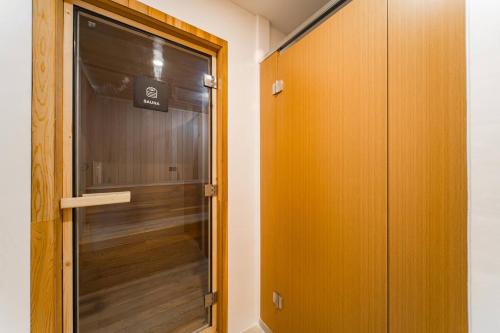 a walk in shower with a glass door in a room at Wing Samui Condo 102 in Nathon Bay