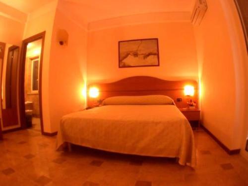 Postel nebo postele na pokoji v ubytování Amaranto Hotel