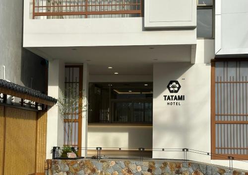 a building with a sign on the side of it at Tatami Hotel Phuket in Ban Ket Ho