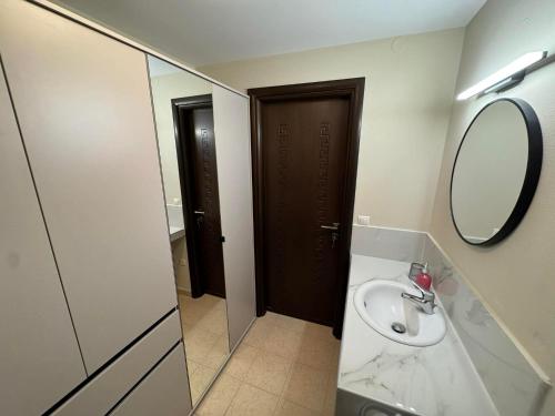 a bathroom with a sink and a mirror at Imperia President in Paralia Katerinis