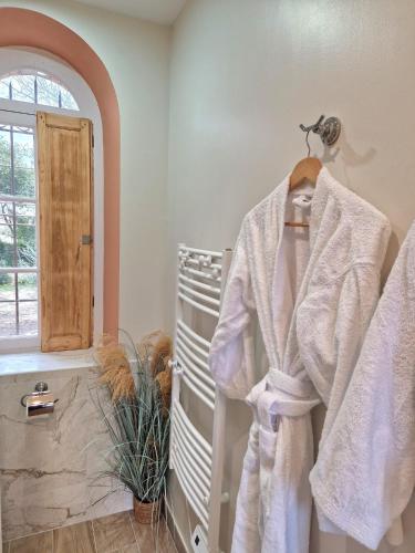 a bathroom with white towels hanging on a rack at Château de Bayssan in Béziers
