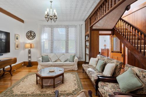 a living room with a couch and a table at Rose Room, Franklin Lodge, Huon Valley in Franklin