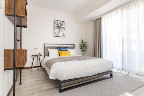 a bedroom with a bed and a large window at Dash Living Ryogoku in Tokyo