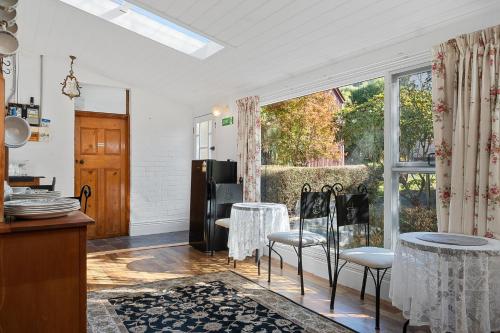 a kitchen with a table and chairs and a large window at Rose Room, Franklin Lodge, Huon Valley in Franklin