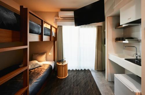 a small room with a bed and a window at Moat Inside Tenjin in Fukuoka