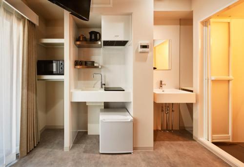 a bathroom with a sink and two sinks at Moat Inside Tenjin in Fukuoka