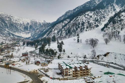 a resort in the snow on a mountain at Badar Resorts & Spa by Stay Pattern Riverside in Sonāmarg