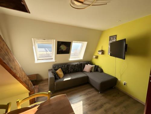 a living room with a couch and a flat screen tv at Apartment Luna in Bovec