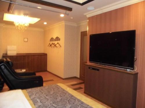 a living room with a large flat screen television at Sari Resort Kashiba (Adult Only) in Kashiba