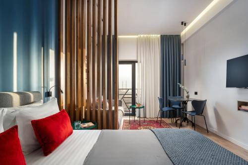 a hotel room with a bed with red pillows at Blueloft 52 I Tashkent City Center in Tashkent