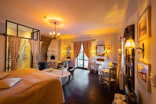 a bedroom with a bed and a bathroom with a tub at Zabola Estate - Transylvania in Zăbala