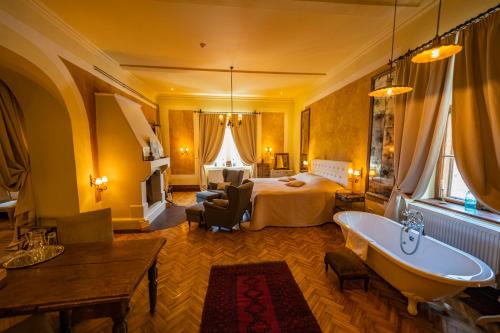 a hotel room with a bed and a bath tub at Zabola Estate - Transylvania in Zăbala