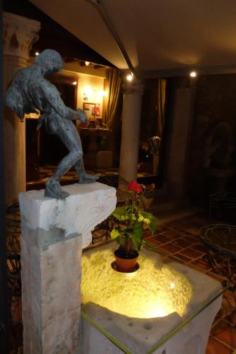 a statue of a man standing on a rock at Hotel Al Ponte Mocenigo in Venice