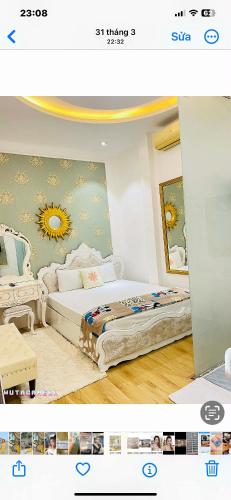 a bedroom with a bed in a room with a sun on the wall at Luxury hotel t&l in Cẩm Phả