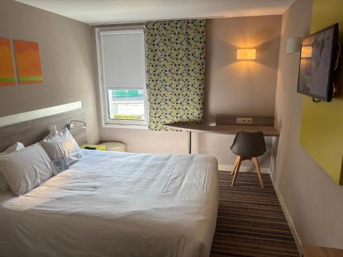 a hotel room with a bed and a window at Kyriad Lyon Est - Saint Bonnet De Mure in Saint-Bonnet-de-Mure