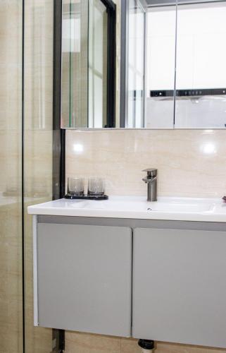 a bathroom with a sink and a mirror at A One Oasis River View Hotel in Phnom Penh
