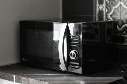 a microwave oven sitting on top of a counter at - Home Sweet Langhe - Room 51 in Alba