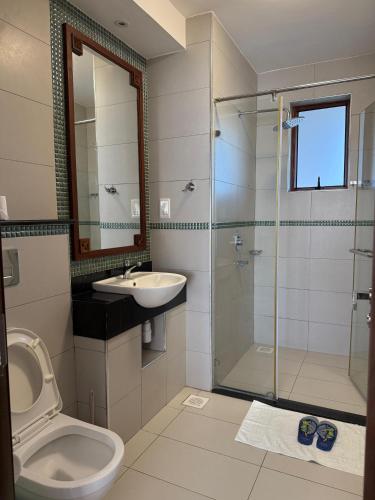 a bathroom with a toilet and a sink and a shower at Sultan Palace Beach Resort - AMANI Apartment CB2-202 in Kikambala