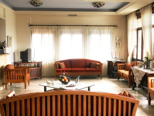 a living room with a couch and a table at Areti Aparthotel in Áptera