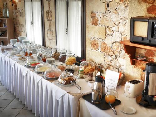 a long white table with food on it at Areti Aparthotel in Áptera