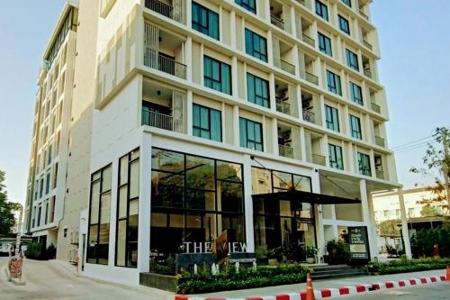 a large building with glass windows on a street at The View Chaengwattana 14 in Bangkok