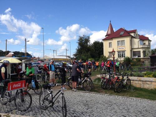 a group of people standing next to their bikes at Pension Villa Else in Heidenau