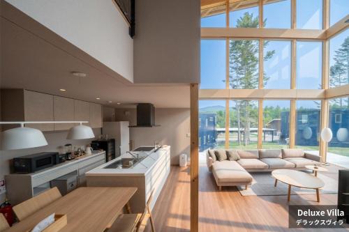 a kitchen and living room with a couch and a table at Rusutsu Hills CENTRO in Rusutsu