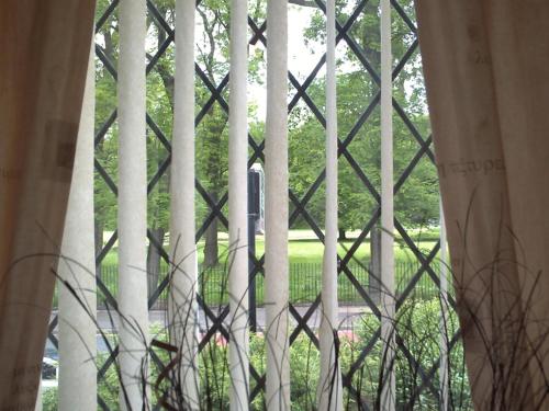 a window with a view of a park with trees at Verdene in Manchester