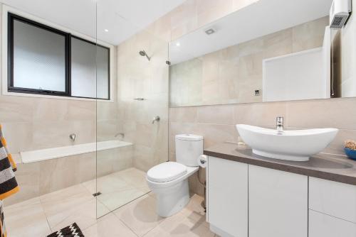 a bathroom with a white toilet and a sink at SeymourViews Apollo Bay in Apollo Bay