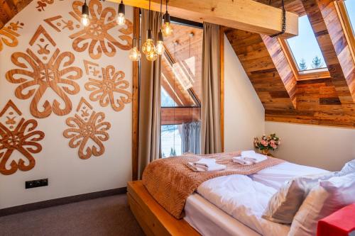a bedroom with a bed and a large window at Tatra Heaven Residence & Jacuzzi in Kościelisko
