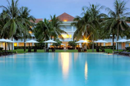 a large swimming pool in front of a hotel at Boutique Hoi An Resort in Hoi An