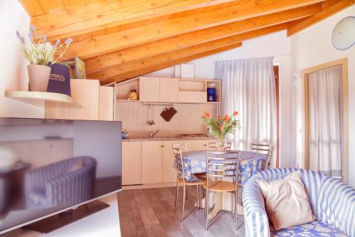 a kitchen and dining room with a table and chairs at Residence Domaso in Domaso