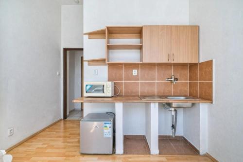 a small kitchen with a table and a microwave at Dusan Apartments in Orlová