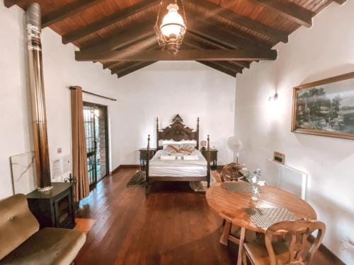 a living room with a bed and a table at Simple Wooden house in Moçarria