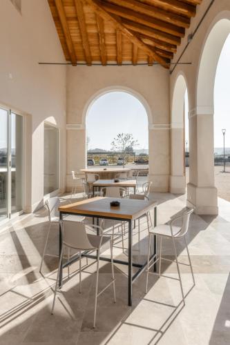 a group of tables and chairs in a building at Casa de Eli - Tenuta Torre Zecchei Wine Experience in Valdobbiadene