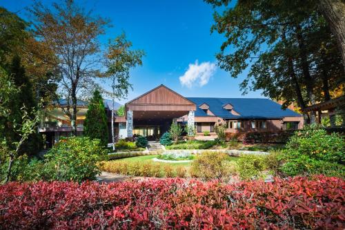 a house with a garden in front of it at Hotel Sierra Resort Hakuba in Hakuba