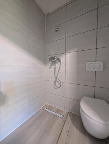 a bathroom with a toilet and a shower at Bright & Sunny Studio in Sesvete