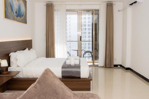 a hotel room with a bed and a balcony at A One Oasis River View Hotel in Phnom Penh