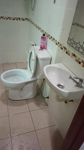 a bathroom with a toilet and a sink at Batu Caves Paradise Hotel in Kuala Lumpur