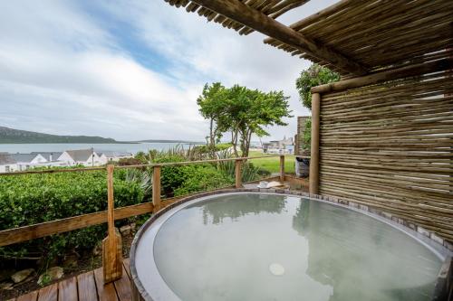a hot tub in the backyard of a house at The Farmhouse Hotel in Langebaan