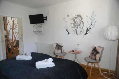 ein Schlafzimmer mit einem Bett, auf dem zwei Handtücher liegen in der Unterkunft Pension Eule in Sankt Kanzian am Klopeiner See