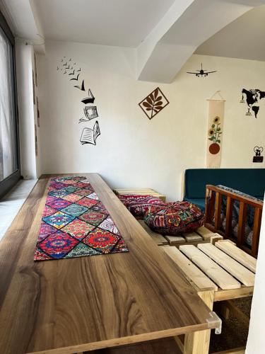 a dining room with a wooden table in a room at Green Door Hostel in Tirana