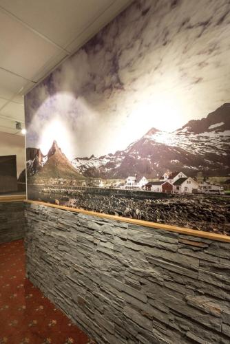 a mural of a mountain on a wall at Senja Hotell in Finnsnes