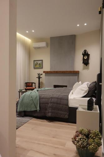a bedroom with a bed and a clock on the wall at Rroji Urban Heritage - Boutique Rooms & Serviced Apartments in City Center in Shkodër