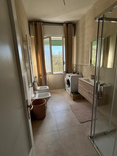 a bathroom with a shower and a toilet and a sink at Casa Mina in Lavagna