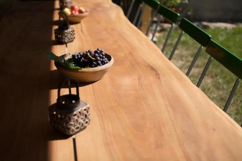 a long wooden table with bowls of fruit on it at Tannerhof Bed & Breakfast in Caines