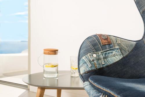 a shoe sitting on a table with a glass of water at Elite Luxury Suites in Oia